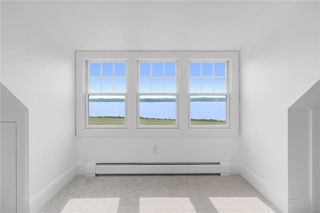 bonus room featuring a baseboard heating unit and light colored carpet