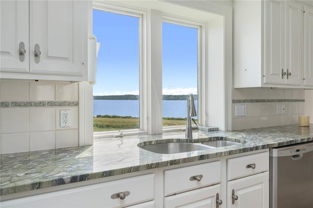 kitchen featuring dishwasher, a water view, sink, and white cabinets