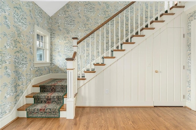 stairway with hardwood / wood-style flooring