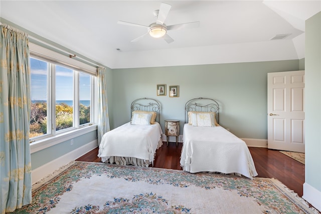 bedroom with dark hardwood / wood-style floors and ceiling fan