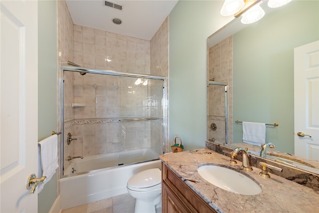 full bathroom featuring toilet, tile flooring, vanity, and combined bath / shower with glass door