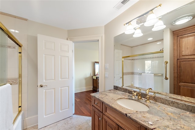 bathroom featuring shower / bath combination with glass door, vanity, and tile flooring