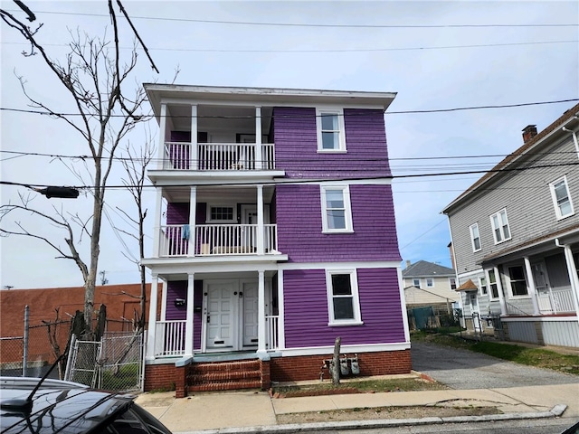 view of front facade featuring covered porch and a balcony