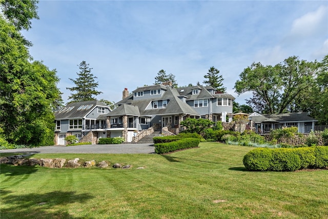 rear view of property with a lawn