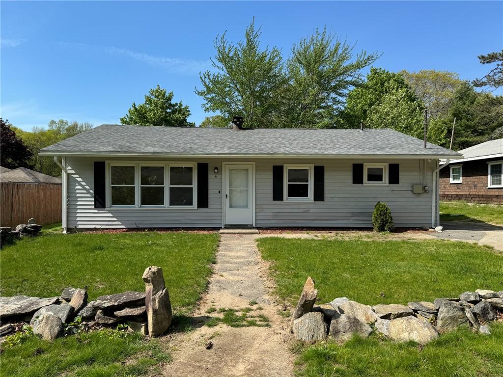 ranch-style house with a front lawn