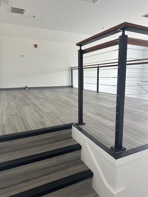 staircase with wood-type flooring