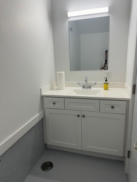 bathroom with vanity and concrete flooring