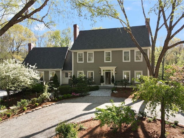 colonial home featuring a chimney