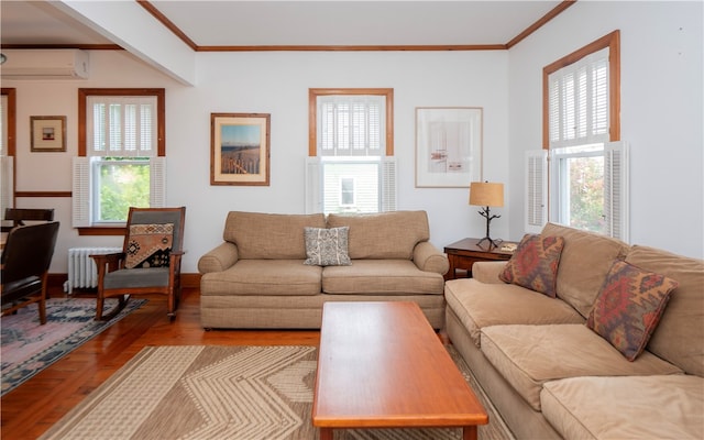 living room featuring light hardwood / wood-style flooring, an AC wall unit, plenty of natural light, and ornamental molding