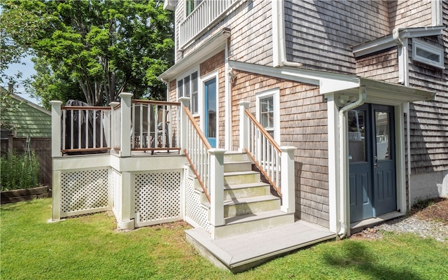 wooden deck featuring a lawn