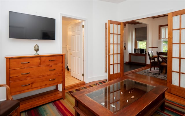 living room featuring french doors and light hardwood / wood-style flooring