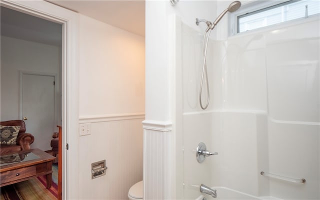 bathroom featuring shower / washtub combination and toilet