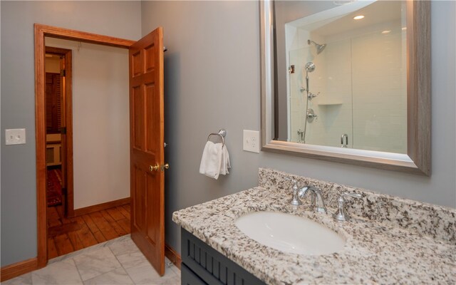 bathroom featuring vanity, hardwood / wood-style flooring, and an enclosed shower