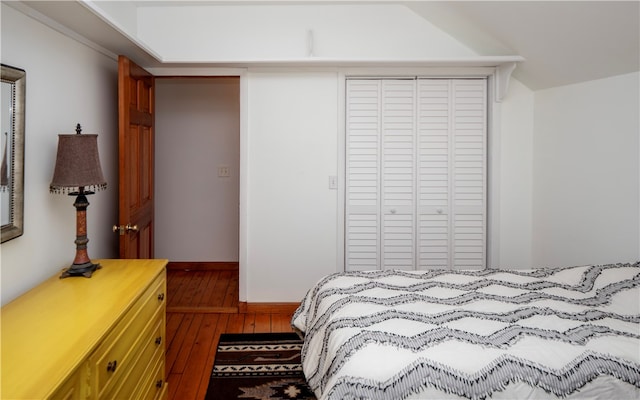 bedroom with hardwood / wood-style floors and a closet