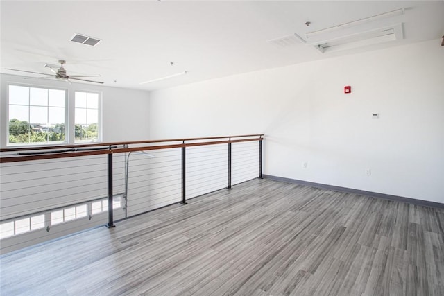 55 John Clarke Rd Unit 3, Middletown, RI 02842 - spare room with wood finished floors, ceiling fan, baseboards, and attic access