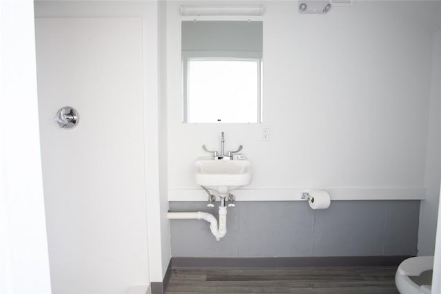 55 John Clarke Rd Unit 3, Middletown, RI 02842 - bathroom with toilet, a sink, and wood finished floors