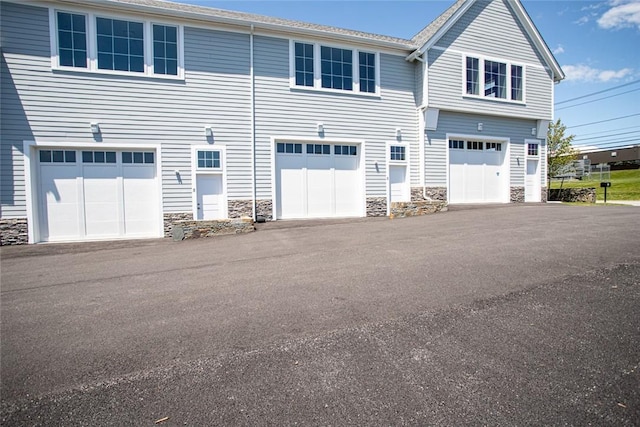 55 John Clarke Rd Unit 3, Middletown, RI 02842 - view of side of home with stone siding and a garage
