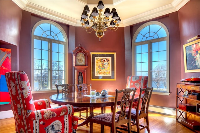 dining room with crown molding, a notable chandelier, hardwood / wood-style floors, and baseboard heating