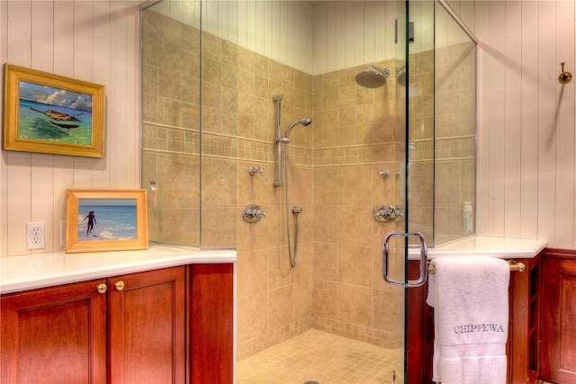 bathroom featuring vanity and a shower with door