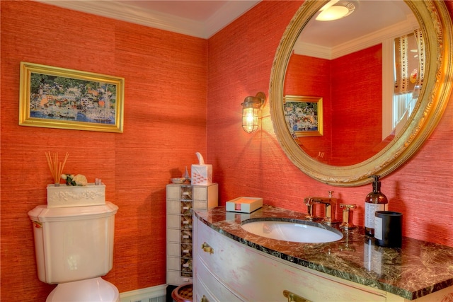 bathroom featuring toilet, crown molding, and large vanity