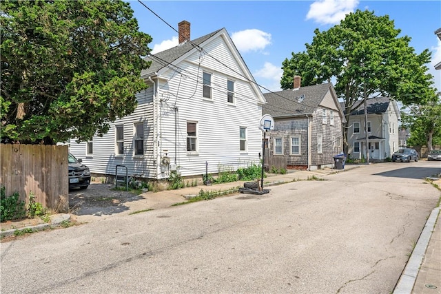 view of front of home featuring fence