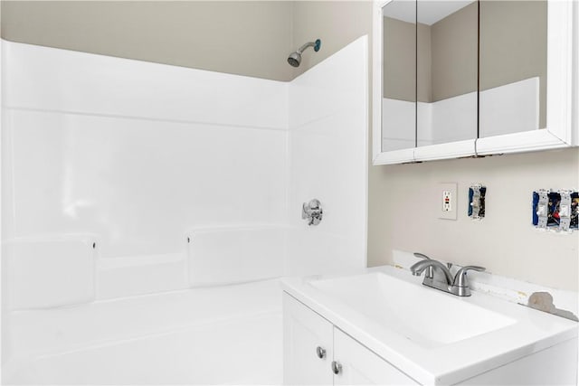 full bathroom featuring a shower and vanity