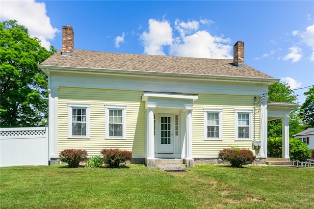 rear view of house with a lawn