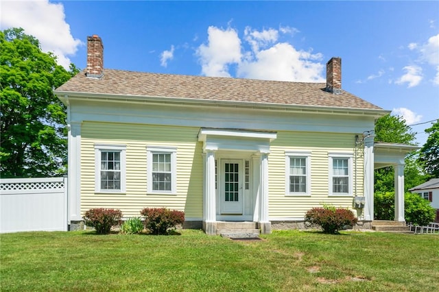 back of property featuring a yard