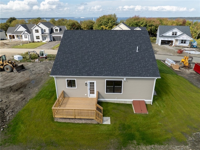 back of property featuring a yard and a deck