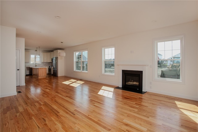 unfurnished living room featuring light hardwood / wood-style floors