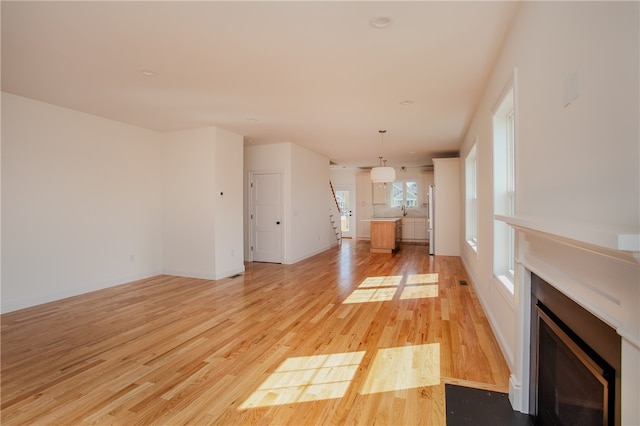 unfurnished living room with light wood-type flooring