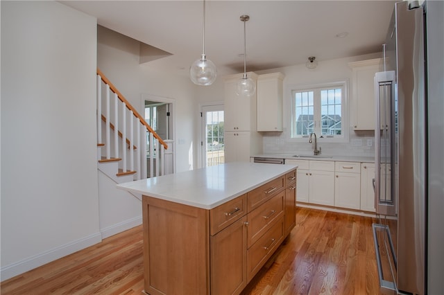 kitchen featuring plenty of natural light, white cabinetry, and a center island