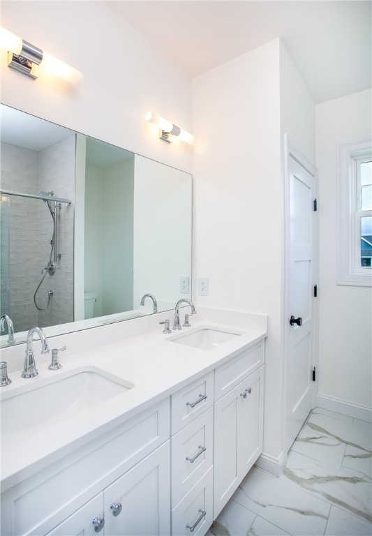 bathroom featuring an enclosed shower, vanity, and toilet