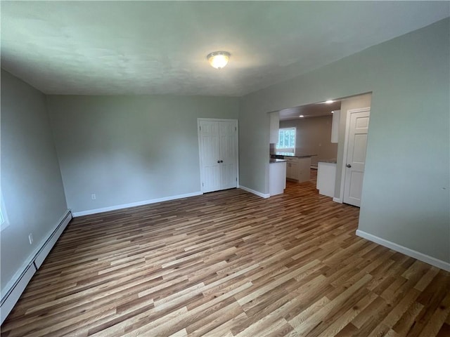 interior space with light hardwood / wood-style flooring and a baseboard radiator