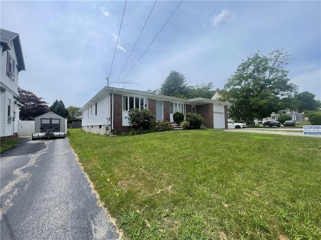 view of front of house with a garage and a front lawn