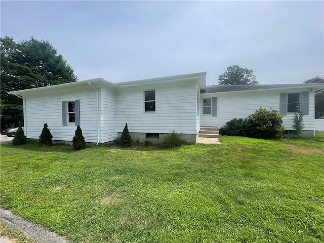 back of property featuring a yard