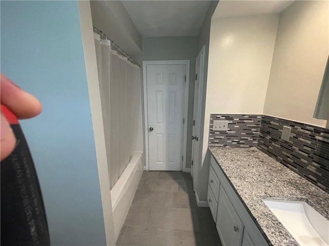 bathroom featuring vanity, decorative backsplash, tile patterned floors, and shower / bathtub combination with curtain