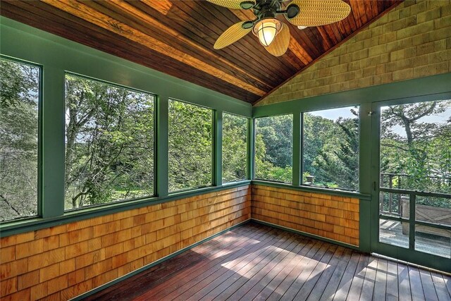 unfurnished sunroom featuring vaulted ceiling, wood ceiling, and ceiling fan