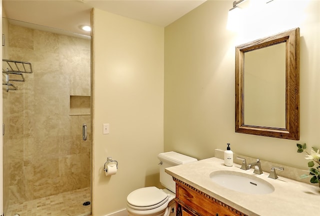 bathroom featuring vanity, toilet, and an enclosed shower