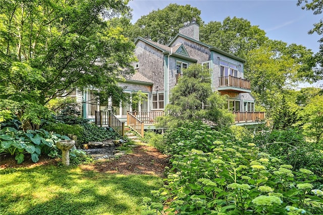 back of house with a lawn