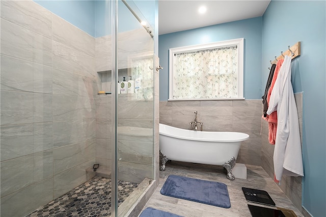 bathroom featuring independent shower and bath and tile walls