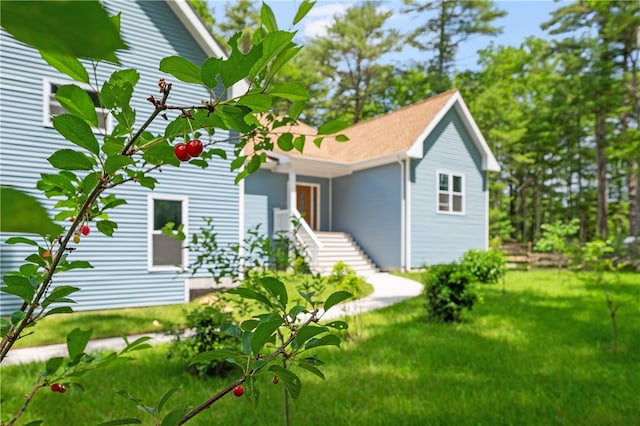 rear view of property featuring a yard