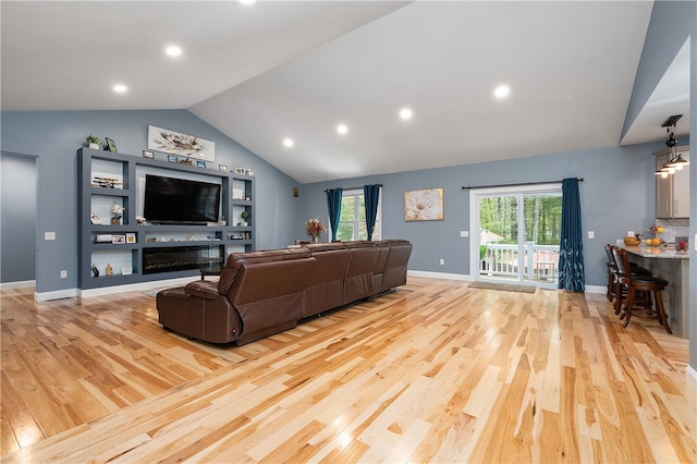 living room featuring light hardwood / wood-style floors and vaulted ceiling