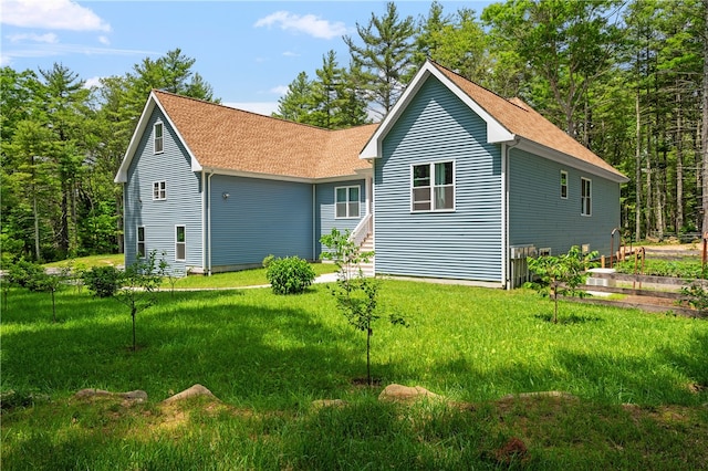 rear view of property with a lawn