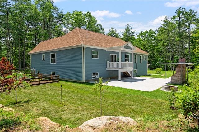 back of house with a patio and a yard