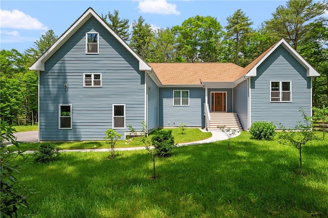 rear view of house with a lawn