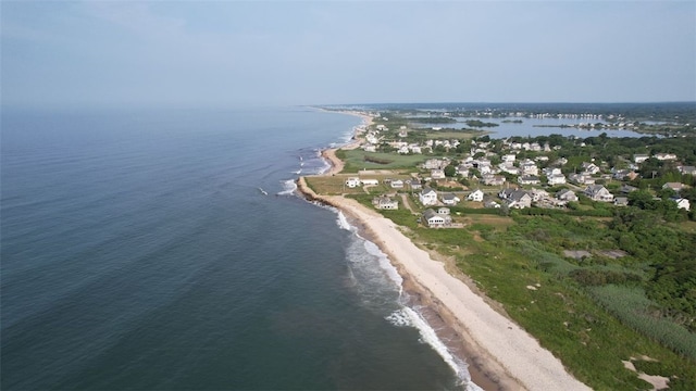 drone / aerial view with a beach view and a water view