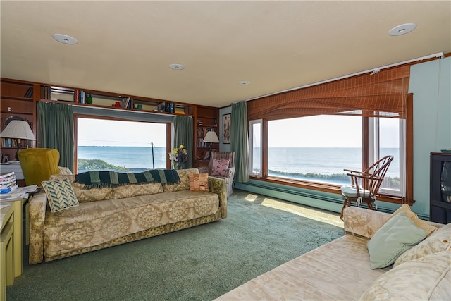 carpeted living room with a baseboard radiator and a water view