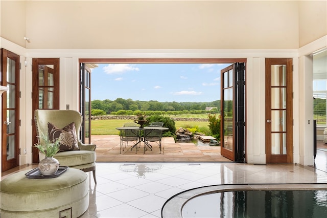 doorway to outside with tile patterned flooring and french doors