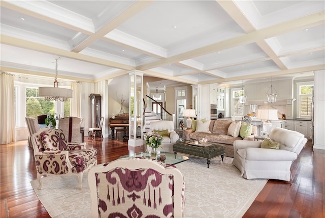 living room featuring beam ceiling, dark hardwood / wood-style flooring, coffered ceiling, and decorative columns